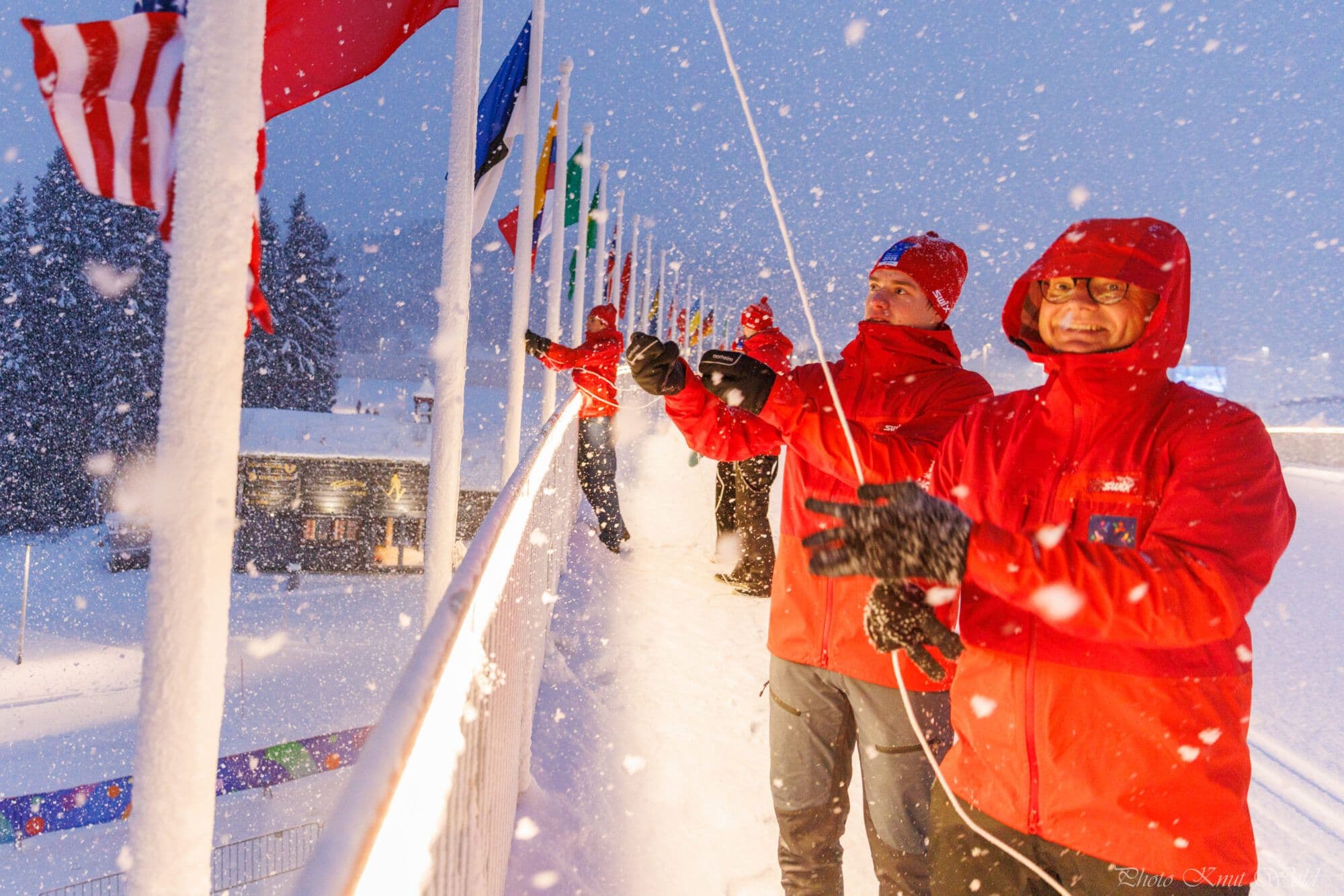 Volunteers at the Ski World Championship raising flags at the arena.
